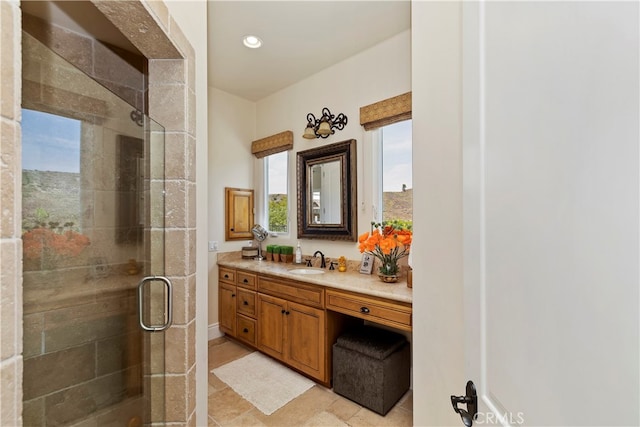 bathroom featuring tile patterned floors, vanity, and a shower with door