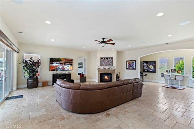 living room featuring light tile patterned floors and ceiling fan