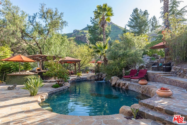 view of pool featuring a gazebo, a mountain view, and a patio