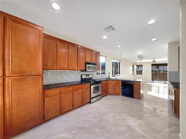 kitchen featuring tasteful backsplash, kitchen peninsula, sink, and stainless steel appliances