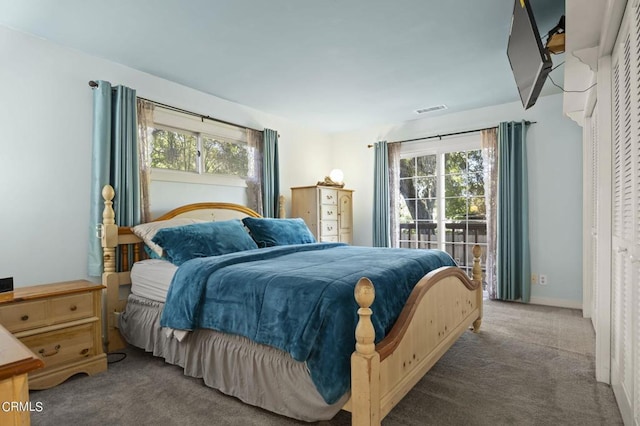 carpeted bedroom featuring visible vents and baseboards