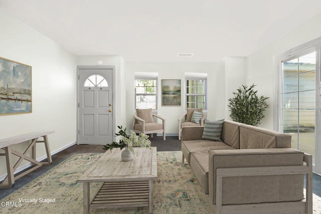 living area featuring visible vents and baseboards