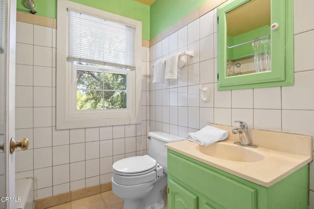 full bath with vanity, a shower with shower curtain, tile walls, toilet, and tile patterned floors