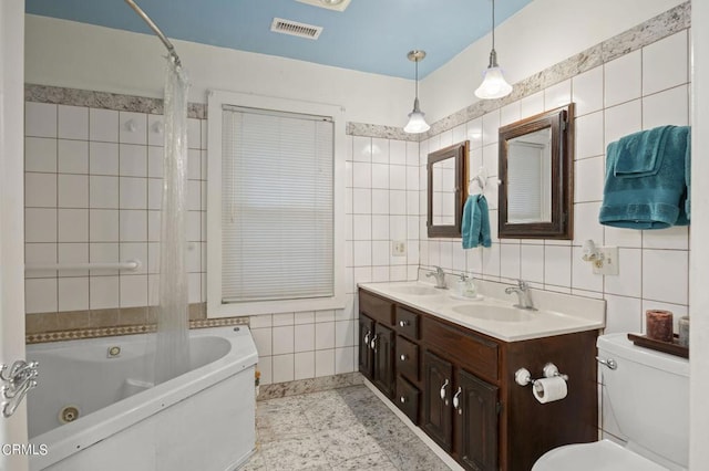 full bath featuring a sink, visible vents, and tile walls