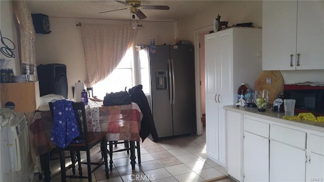 kitchen featuring white cabinets, light tile patterned floors, stainless steel refrigerator with ice dispenser, and ceiling fan