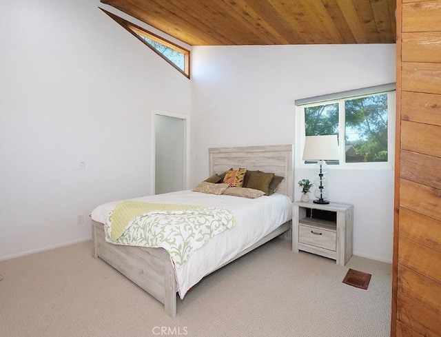 bedroom featuring light carpet, vaulted ceiling, and wooden ceiling