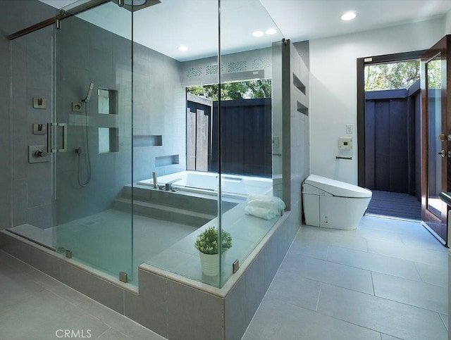 bathroom with tile patterned flooring and shower with separate bathtub