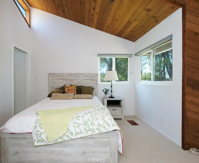 bedroom featuring vaulted ceiling, carpet flooring, wood ceiling, and multiple windows