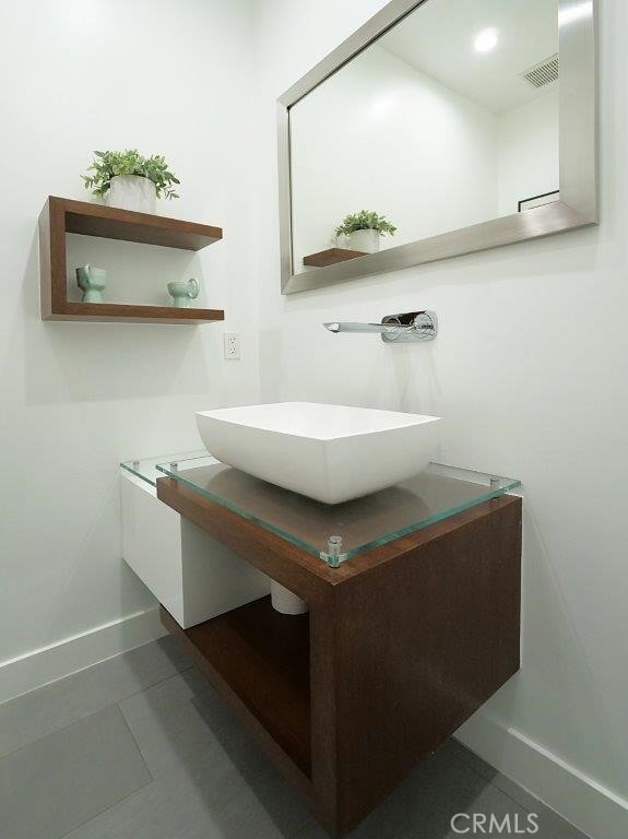 bathroom with tile patterned flooring and vanity