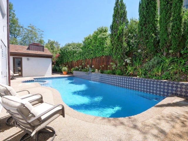 view of swimming pool with an in ground hot tub and a patio area