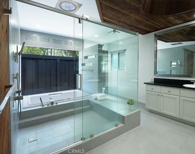 bathroom with vanity and independent shower and bath