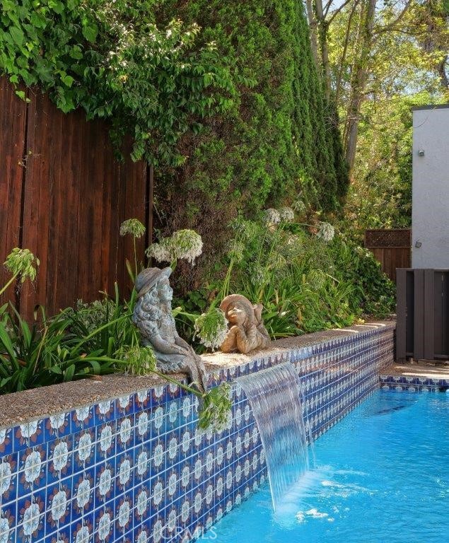 view of pool with pool water feature