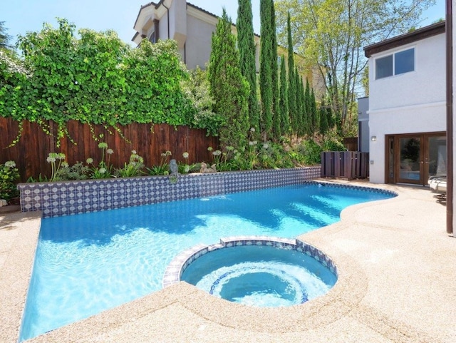 view of pool featuring an in ground hot tub