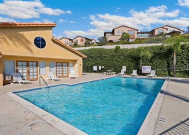 view of pool featuring a patio and french doors