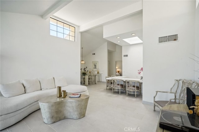 tiled living room featuring high vaulted ceiling and beamed ceiling