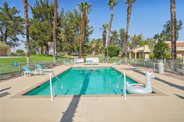 view of pool featuring a patio area and a lawn