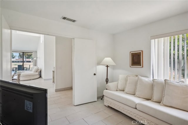 living room featuring light tile patterned flooring and vaulted ceiling