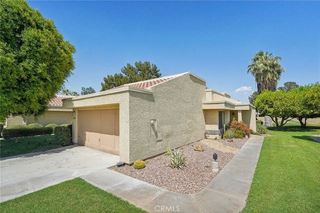 view of front of home with a garage and a front lawn