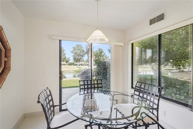 dining space featuring a water view and plenty of natural light