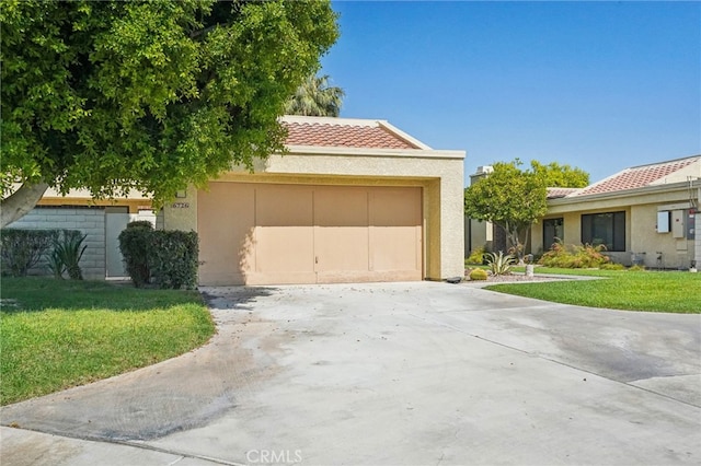 view of front of property with a front lawn and a garage