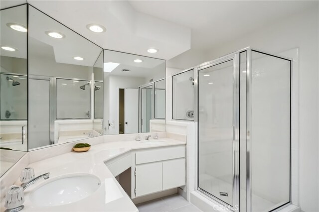 bathroom with vanity, a shower with shower door, and tile patterned flooring