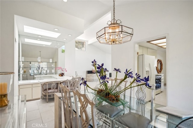 tiled dining room featuring a chandelier