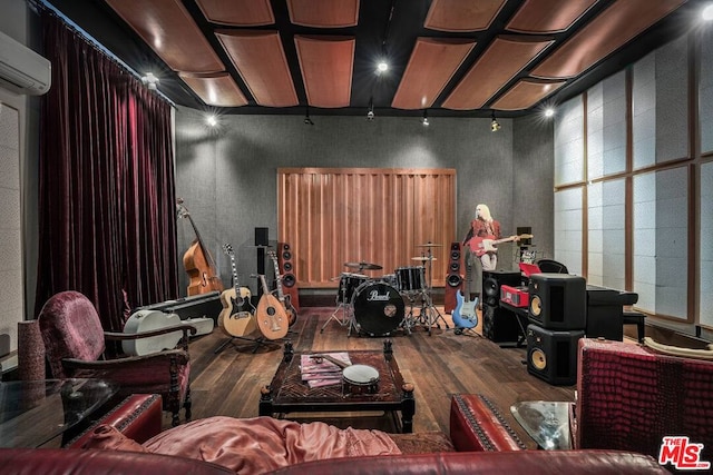 cinema featuring a wall unit AC and wood-type flooring