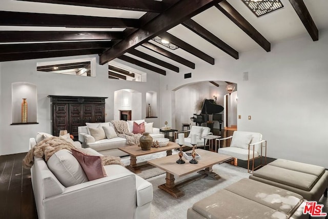 living room featuring beam ceiling, high vaulted ceiling, and wood-type flooring