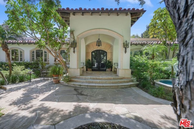 view of exterior entry featuring french doors