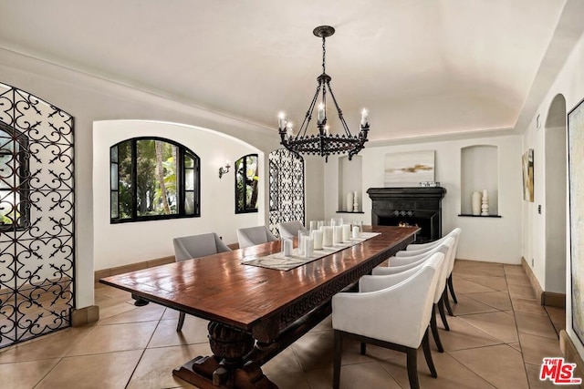 tiled dining space with a chandelier