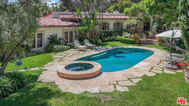 view of swimming pool featuring an in ground hot tub, french doors, a yard, and a patio area