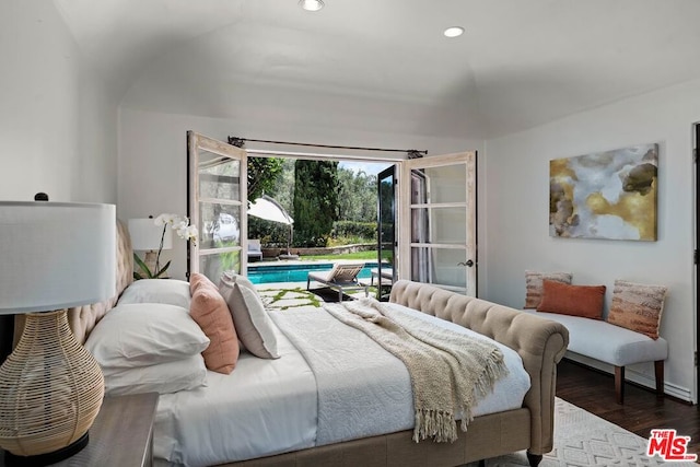 bedroom with access to exterior, dark hardwood / wood-style flooring, and lofted ceiling