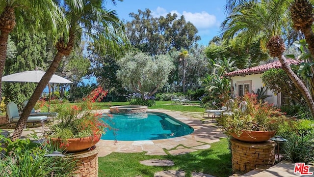 view of swimming pool with an in ground hot tub, a yard, and a patio