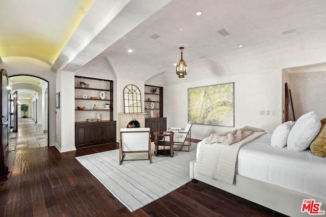 bedroom with a chandelier and dark hardwood / wood-style floors