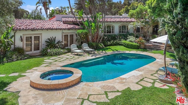 view of pool with a patio area, an in ground hot tub, and french doors