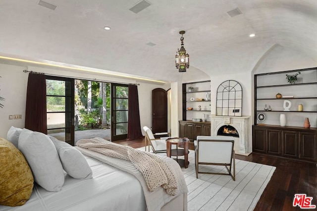 bedroom with dark wood-type flooring and lofted ceiling