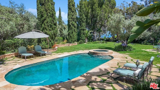 view of pool featuring an in ground hot tub, a patio, and a lawn