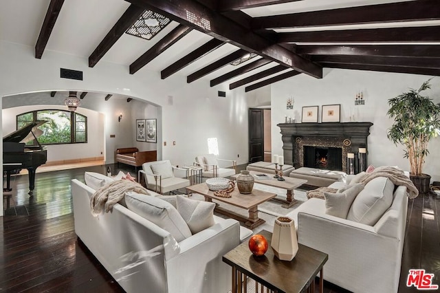 living room with a fireplace, lofted ceiling with beams, and dark hardwood / wood-style floors