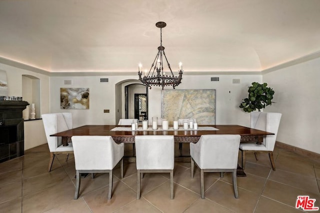 tiled dining space with a chandelier