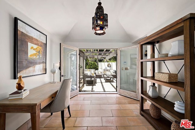 entryway with french doors, light tile patterned floors, and lofted ceiling