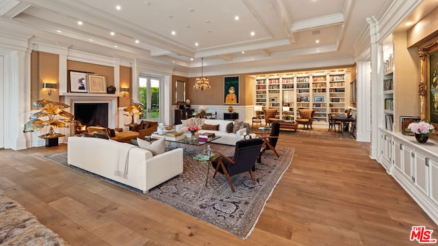 living room featuring coffered ceiling, light hardwood / wood-style floors, and crown molding