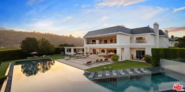 back of property featuring a yard and a patio area