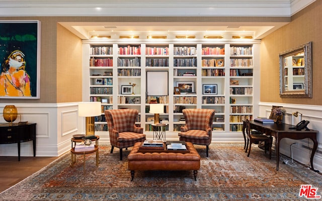 living area featuring dark wood-type flooring and ornamental molding