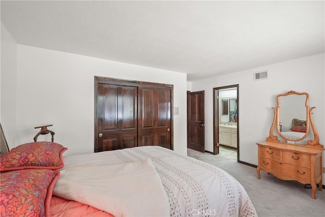 carpeted bedroom with sink, connected bathroom, and a closet