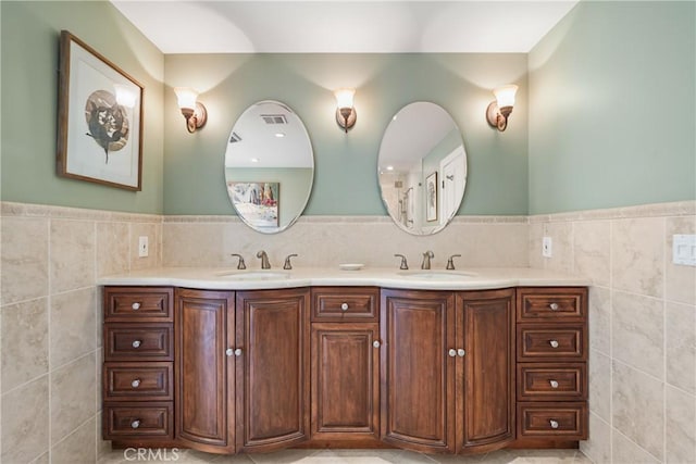 bathroom with vanity and tile walls