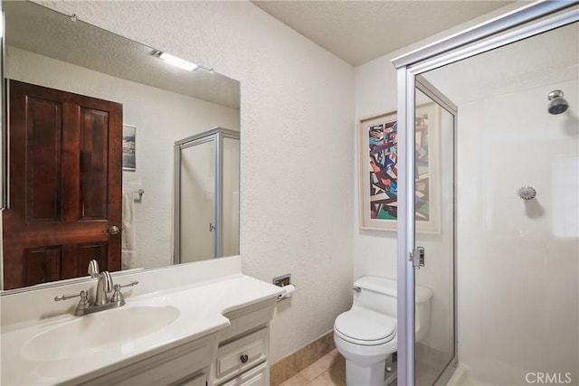 bathroom featuring tile patterned floors, vanity, an enclosed shower, and toilet