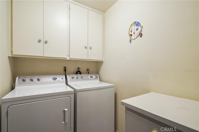 laundry area with cabinets and washing machine and clothes dryer