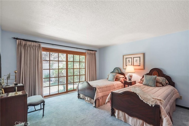 bedroom with access to outside, light colored carpet, and a textured ceiling