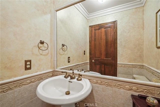 bathroom featuring crown molding and sink