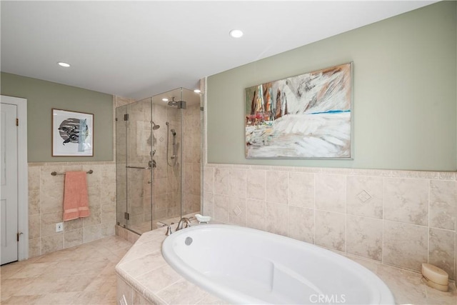 bathroom featuring tile patterned floors, shower with separate bathtub, and tile walls